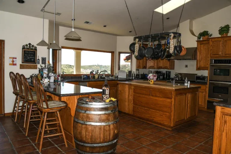 Cozy kitchen at Inn at the Pinnacle featuring wine barrel and chairs.
