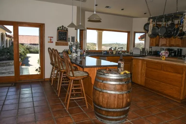 Charming kitchen at Inn at the Pinnacle adorned with wine barrel and chairs.