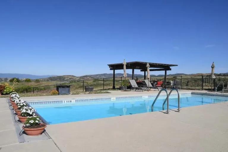 Outdoor pool surrounded by patio furniture at Inn at the Pinnacles.
