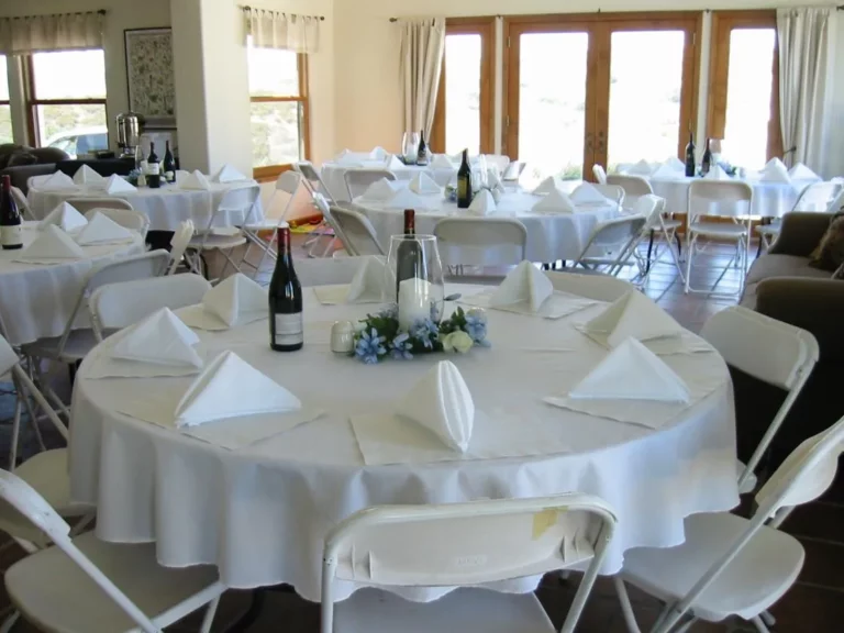 white wedding tables set up for a wedding ceremony or reception.
